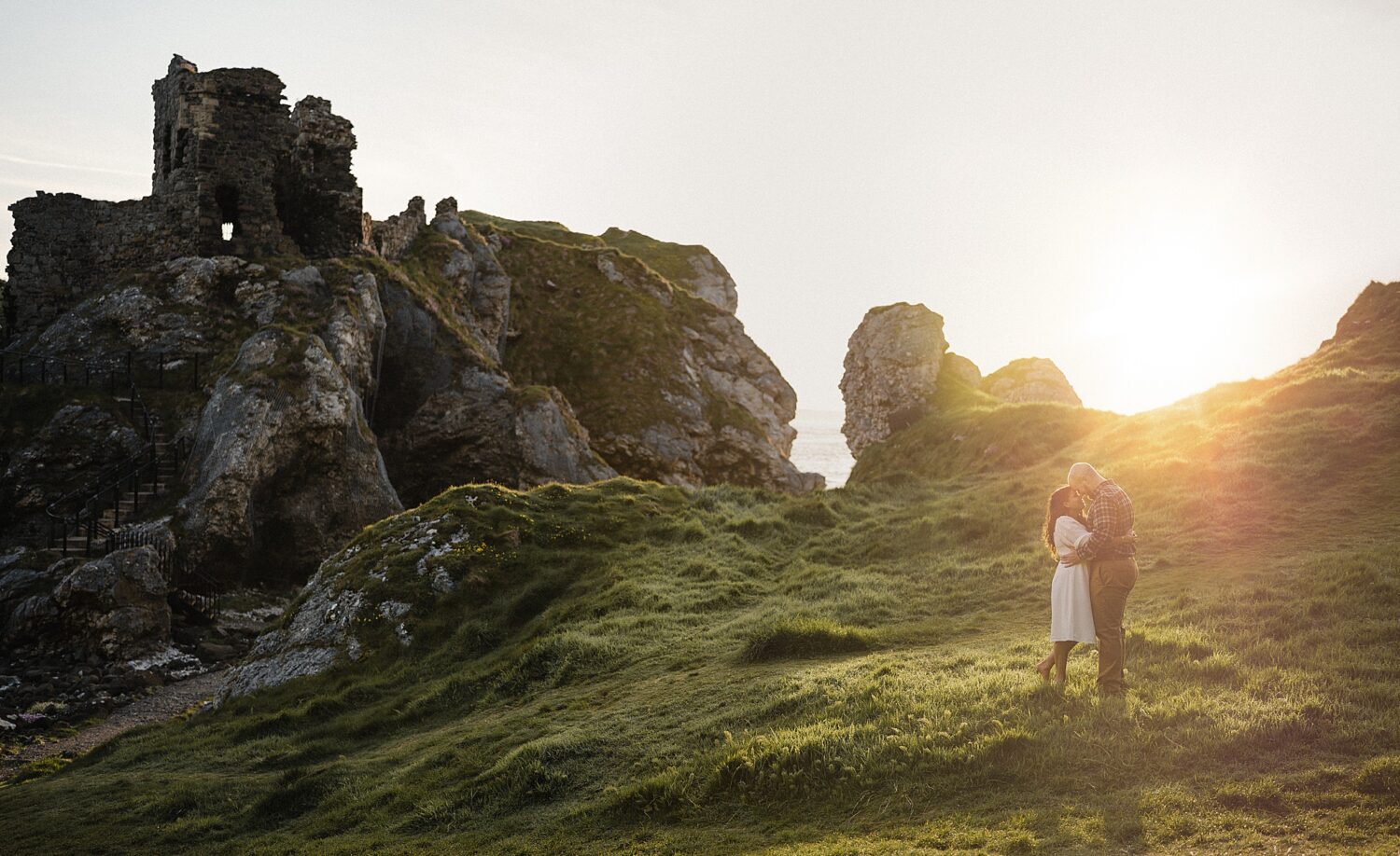 couple hugging during sunrise shoot at Kinbane Castle ruins