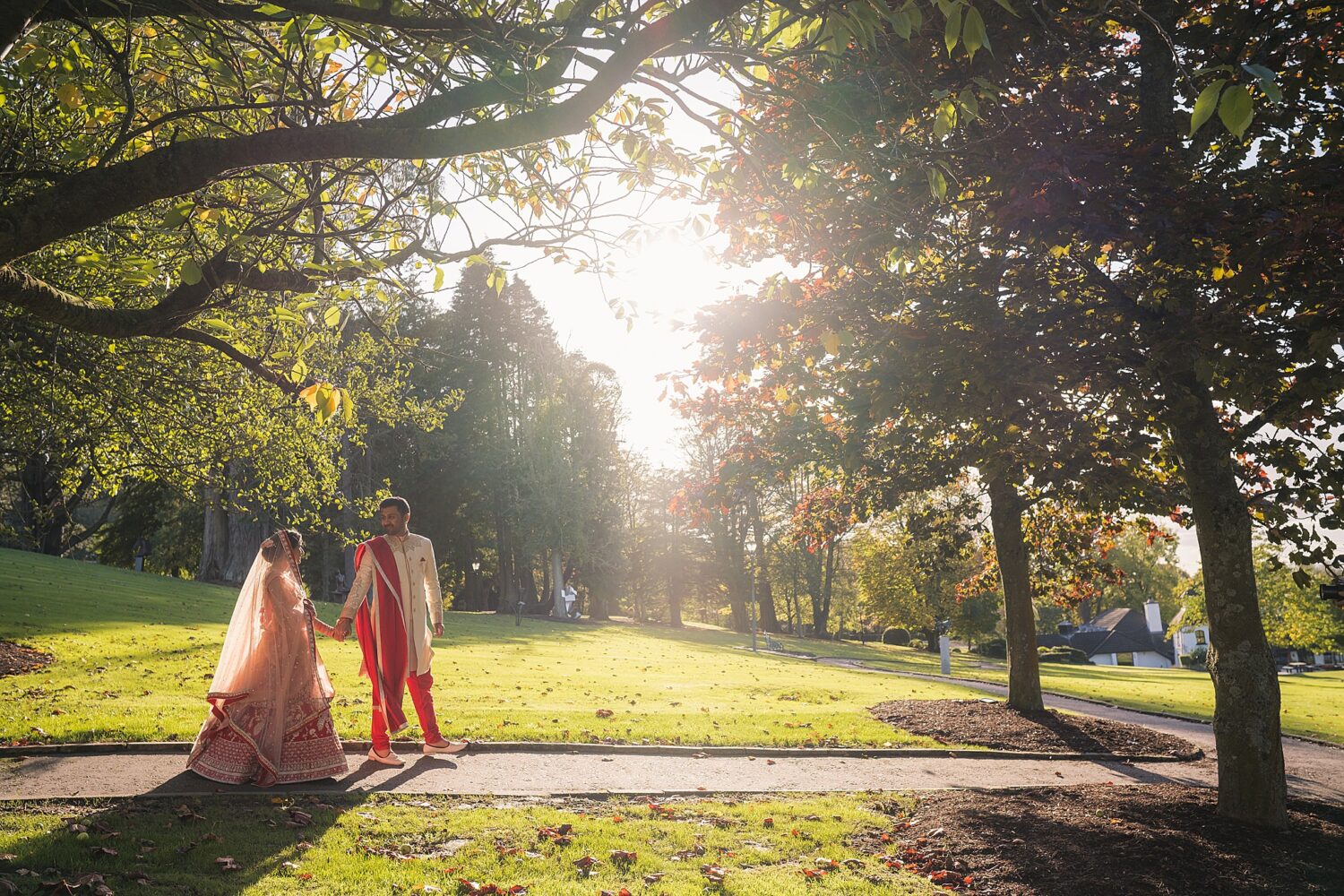 Indian bride & groom walking in the sunlight