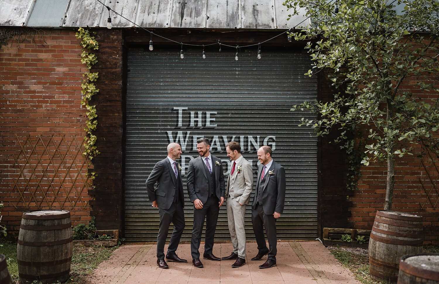 groom and grooms party outside at wool tower