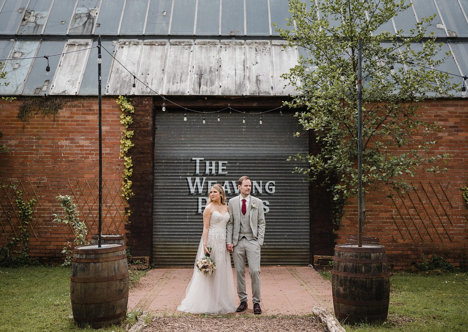 bride and groom holding hands at wool tower ballymena